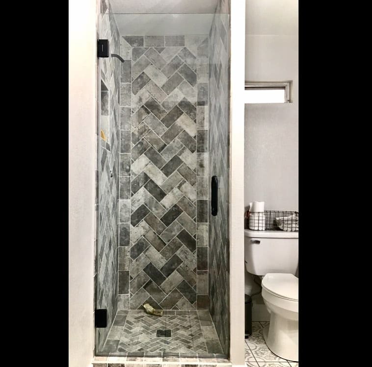 Corner Frameless Enclosure - Brushed brass hinges and premium hardware - Las Vegas custom shower door project
