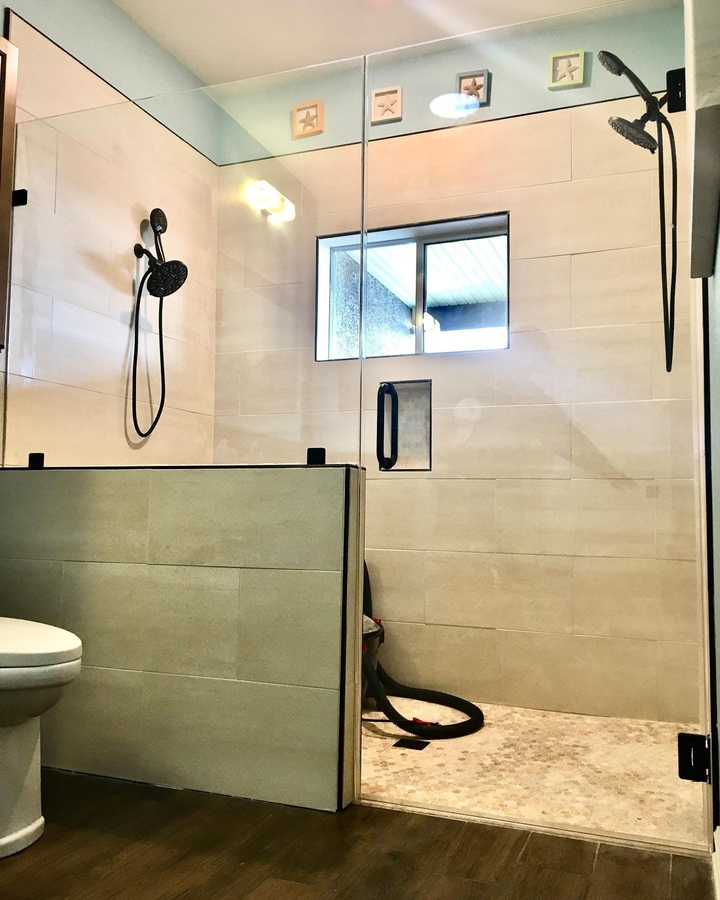 Frameless shower enclosure with brushed nickel hardware installed in Summerlin master bathroom